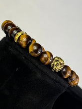 Load image into Gallery viewer, 10mm Brown Tiger’s Eye- Gold Lion and Eye of Horus Bracelet
