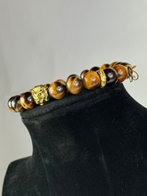 Load image into Gallery viewer, 10mm Brown Tiger’s Eye- Gold Lion and Eye of Horus Bracelet
