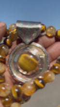 Load and play video in Gallery viewer, Circle Tiger Eye Pendant
