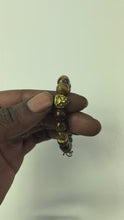 Load and play video in Gallery viewer, 10mm Brown Tiger’s Eye- Gold Lion and Eye of Horus Bracelet
